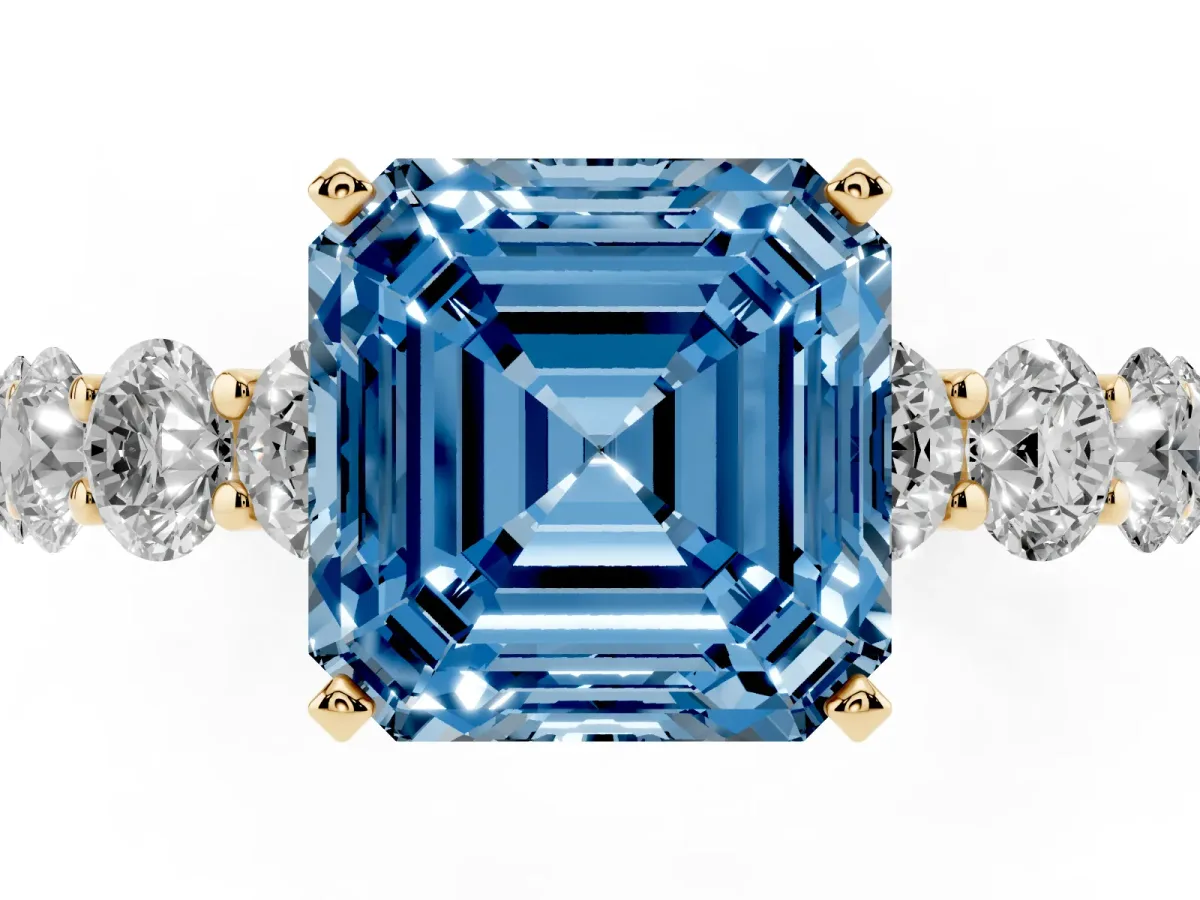 Fancy Blue Asscher Cut Diamond Prong Setting with Side Stones on a Pave Band Yellow gold