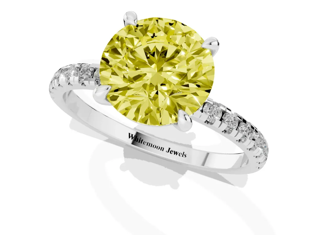 Fancy Yellow Round Cut Diamond Brilliant Solitaire Ring with Pavé Band and Four-Prong Setting White gold