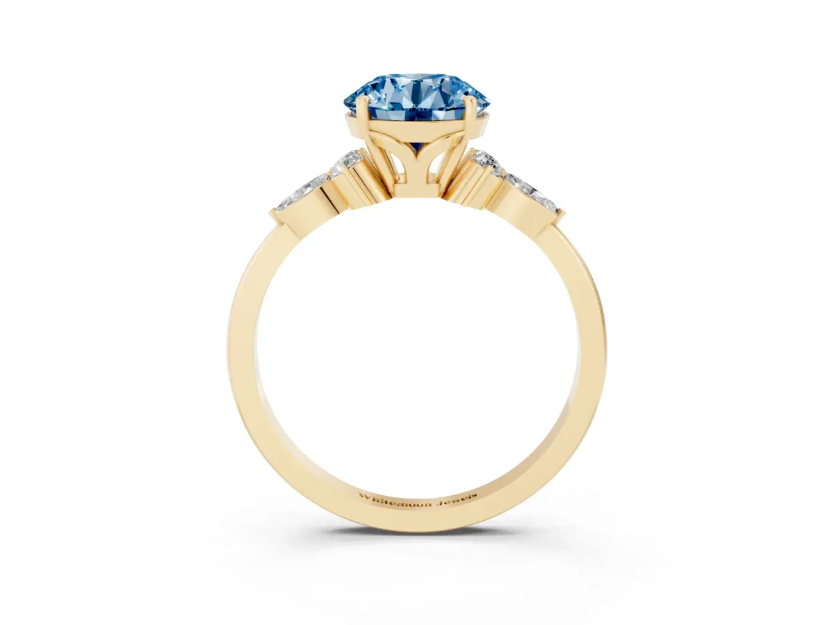 Fancy Blue Round Cut Brilliant Diamond Solitaire Ring with Pear Side Stones and Four-Prong Setting Yellow gold
