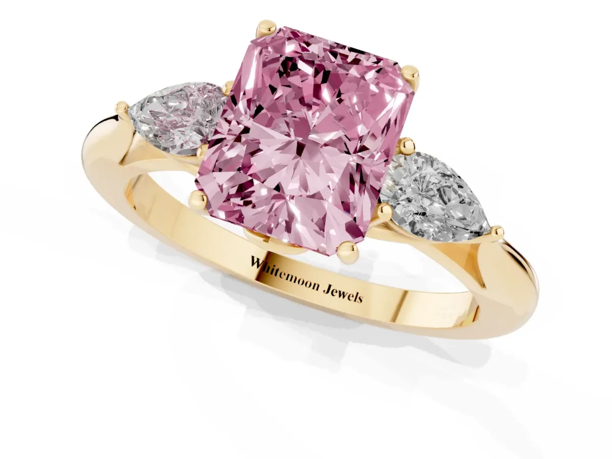 Fancy Pink Three-Stone Radiant Cut Brilliant Diamond Solitaire Ring with Tapered Band and Four-Prong Setting Yellow gold
