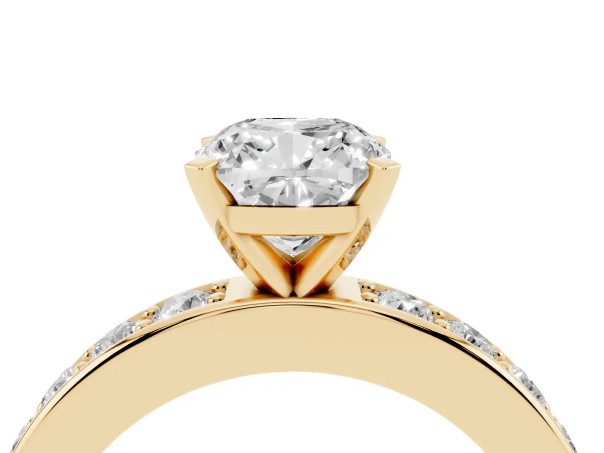 Cushion Cut Diamond Engagement Ring with Channel Set Round Band and Prong Setting Yellow gold