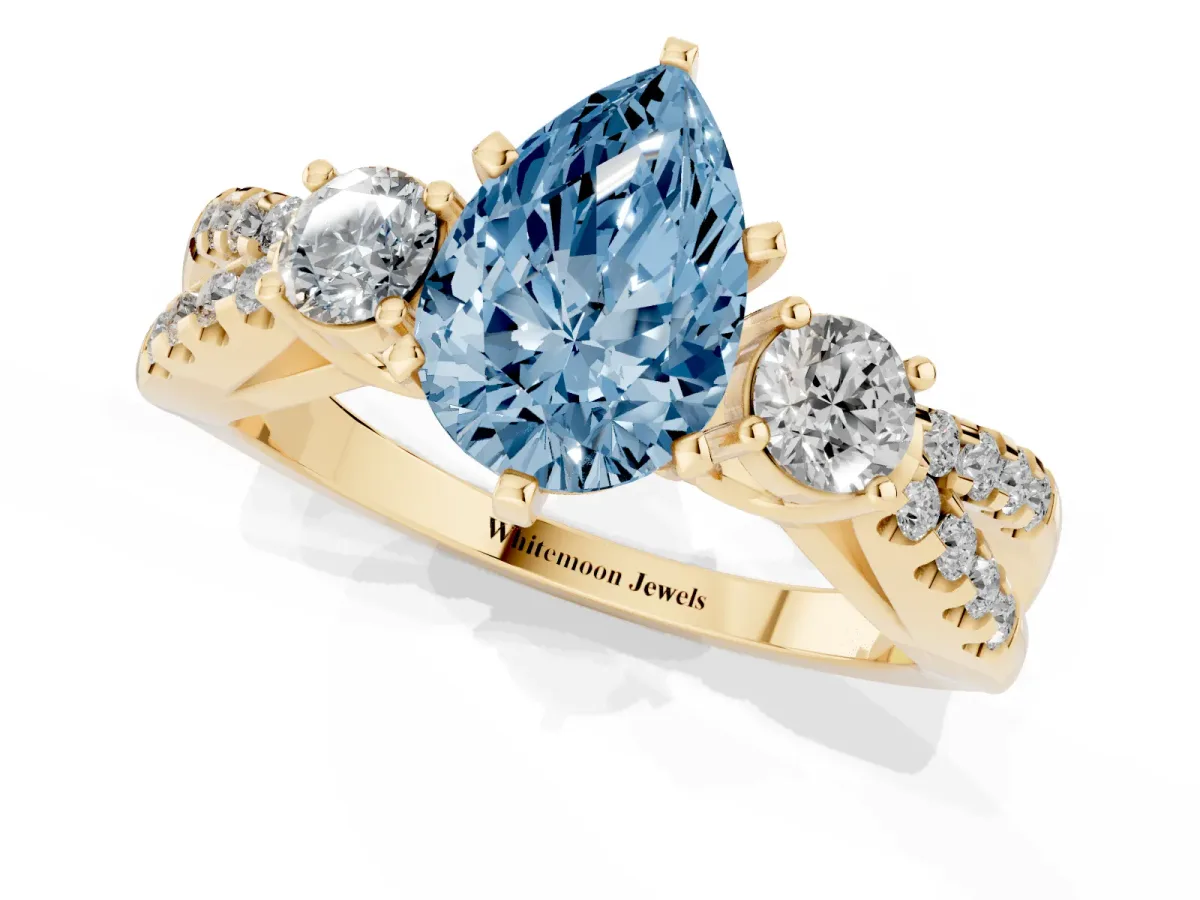 Fancy Blue Pear Cut Diamond Three-Stone Ring with Pavé Split Shank and Four-Prong Setting Yellow gold