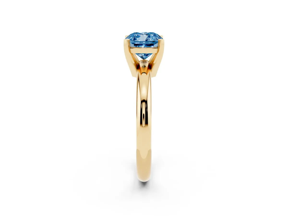 Fancy Blue Cushion Cut Diamond Solitaire Engagement Ring with Round Band and Four-Prong Setting Yellow gold