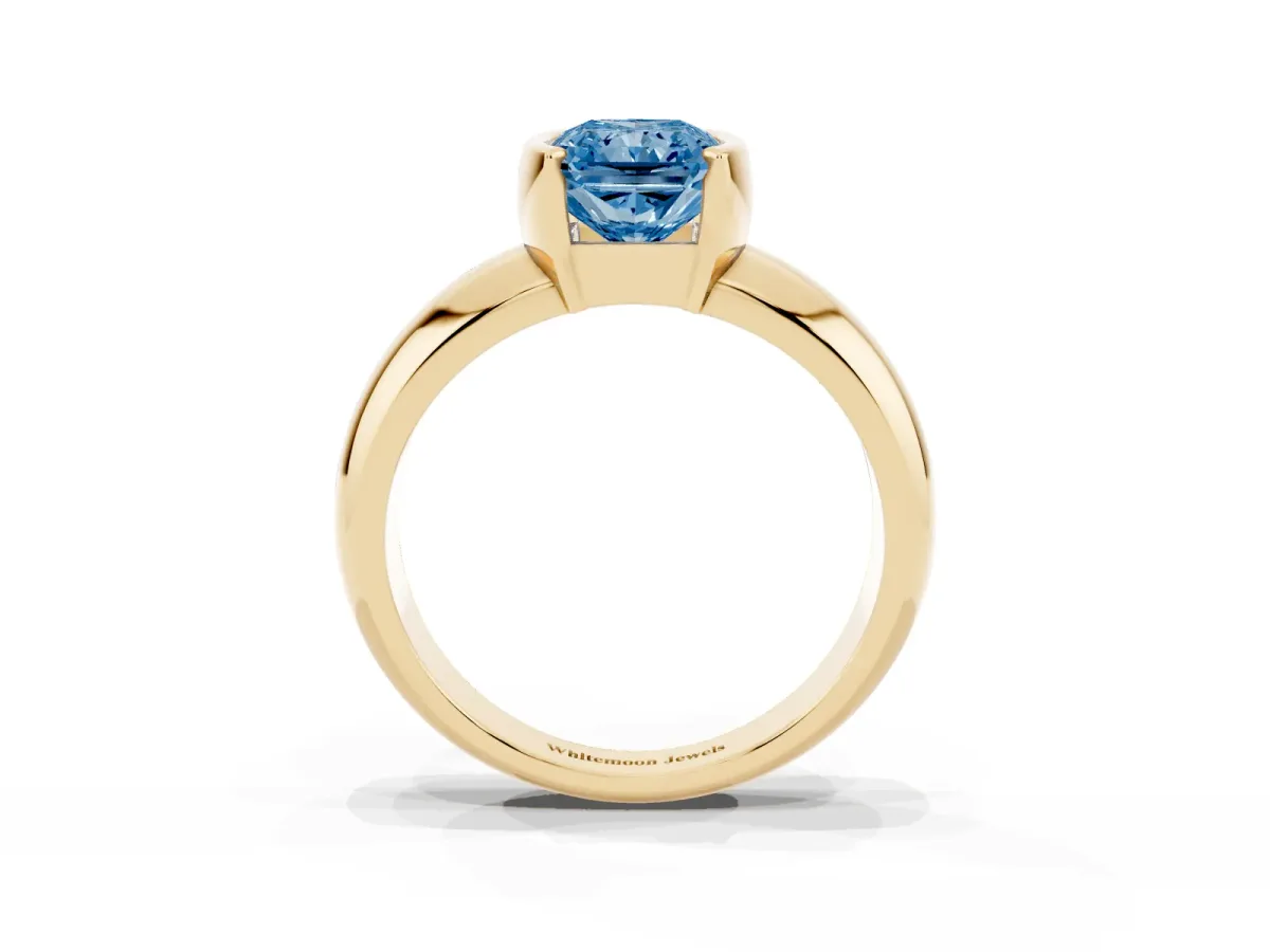 Fancy Blue Radiant Cut Solitaire Tension Set Diamond Ring with Wide Band Yellow gold