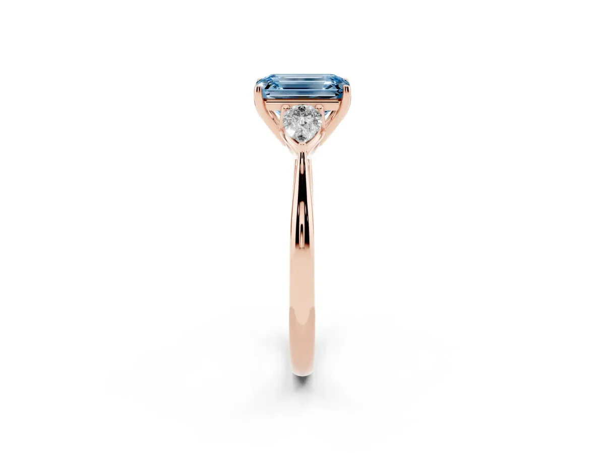 Fancy Blue Three-Stone Emerald Cut Diamond Ring with Pear Side Stones in Four-Prong Setting Rose gold
