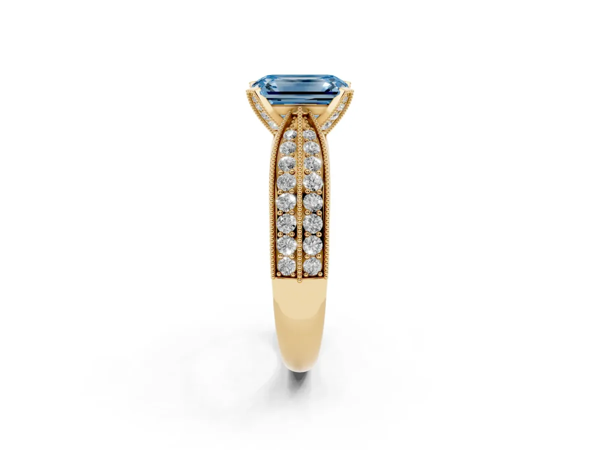 Fancy Blue Emerald Cut Diamond Solitaire Ring with Milgrain Round Pavé Band and Prong Setting Yellow gold