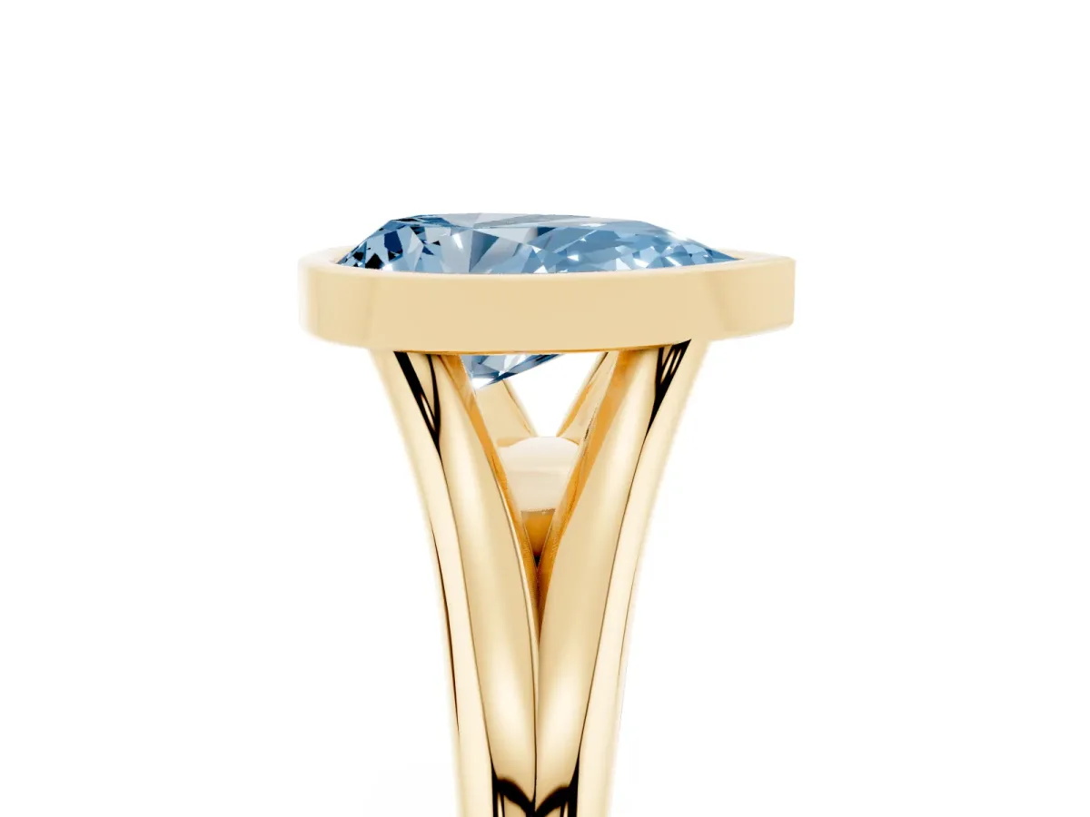 Fancy Blue Bezel Set Pear Cut Cut Solitaire Ring with Tapered Band Yellow gold