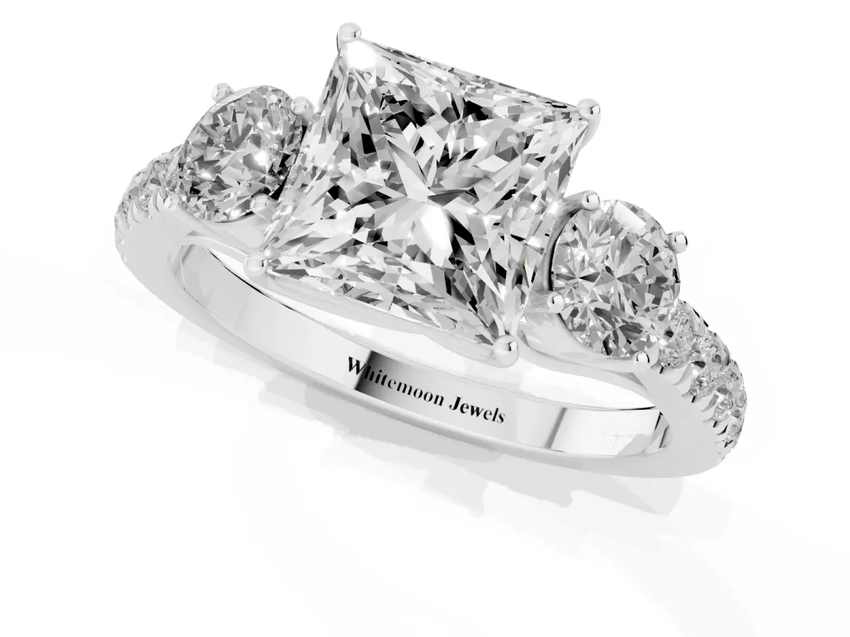 Princess Cut Cut Diamond Three-Stone Ring with Round Side Stones and Pavé Band Platinum