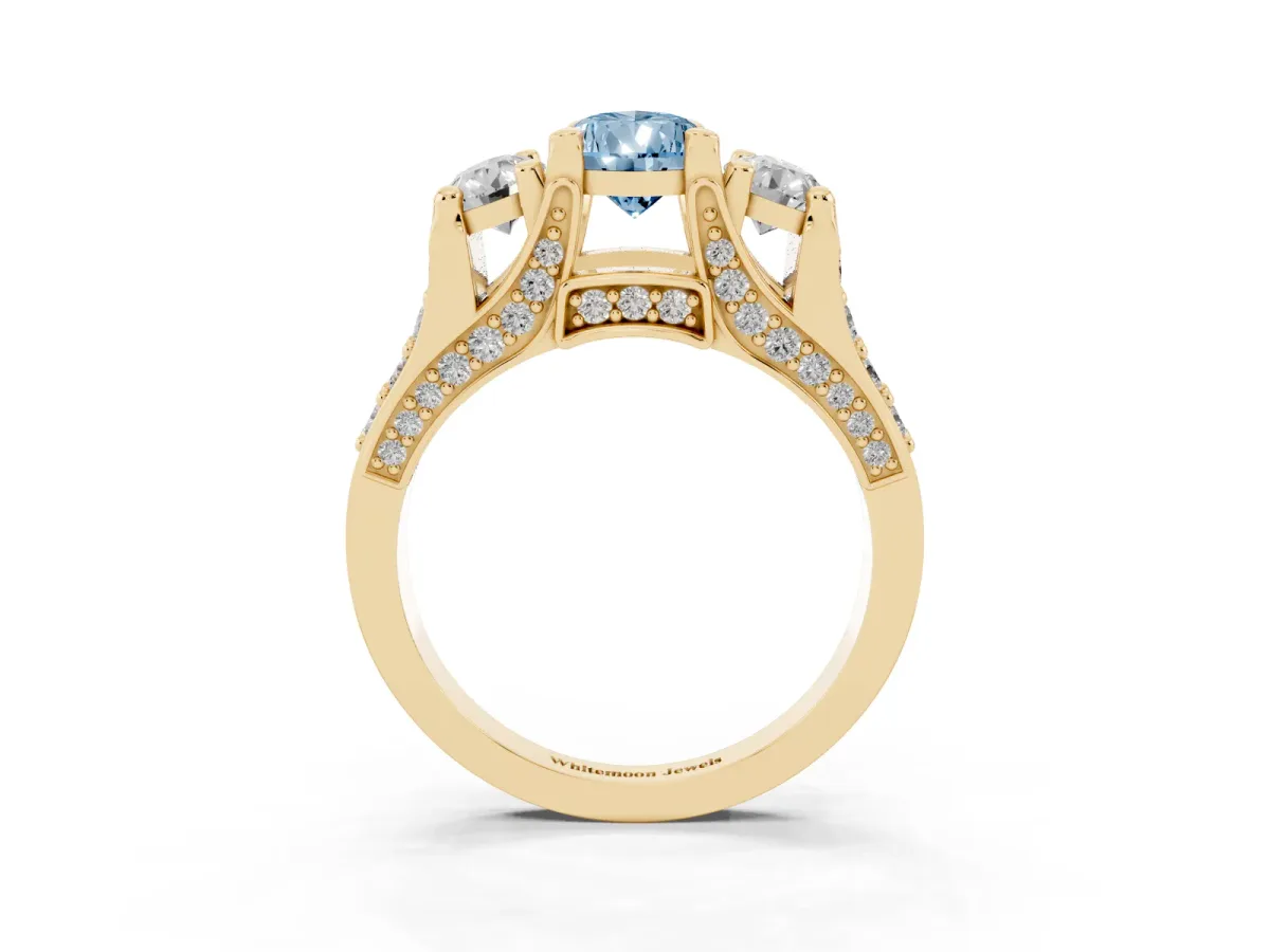 Fancy Blue Pear Cut Diamond Three-Stone Ring with Channel Set Band and Four-Prong Setting Yellow gold
