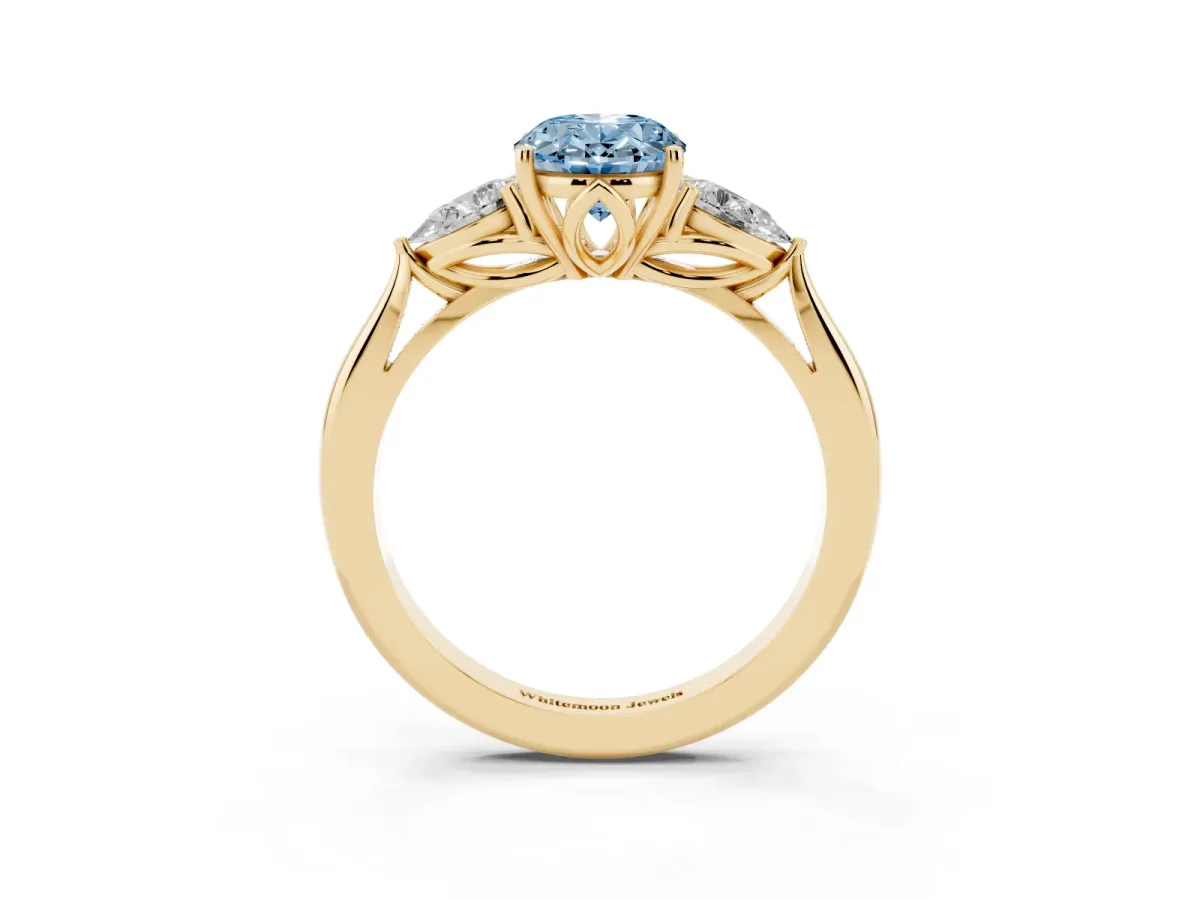 Fancy Blue Three-Stone Oval Cut Diamond Ring with Pear Side Stones in Four-Prong Setting Yellow gold