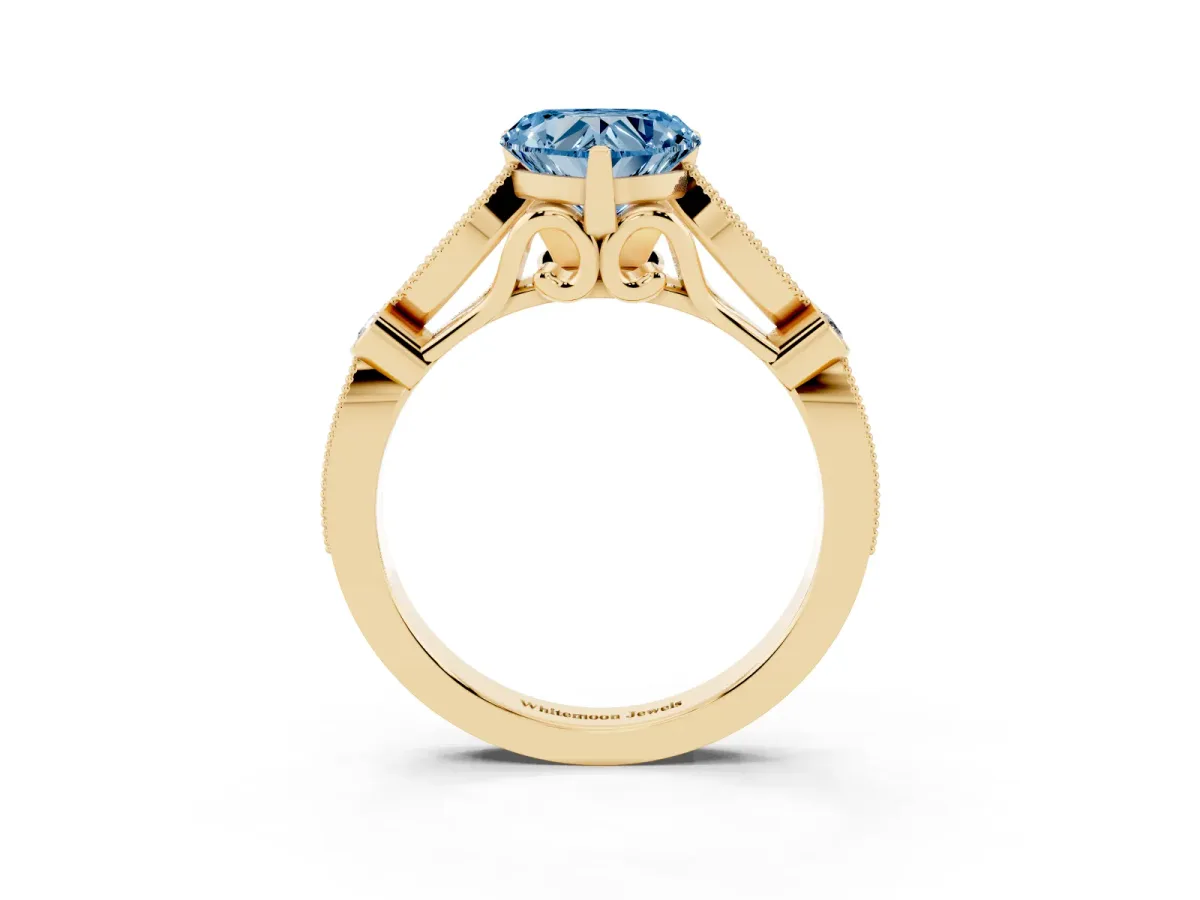 Fancy Blue Heart Cut Cut Diamond with Milgrain Marquise and Bezel Accents on a Solitaire Band with Prong Setting Yellow gold