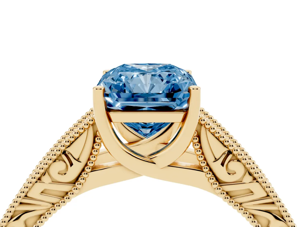 Fancy Blue Radiant Cut Diamond Solitaire Ring with Engraved Band and Four-Prong Setting Yellow gold