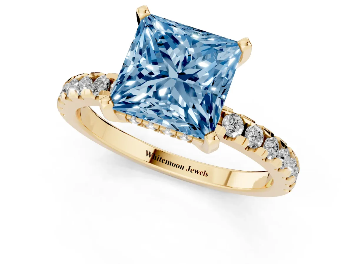Fancy Blue Princess Cut Diamond Solitaire Ring with Round Pavé Band and Four-Prong Setting Yellow gold