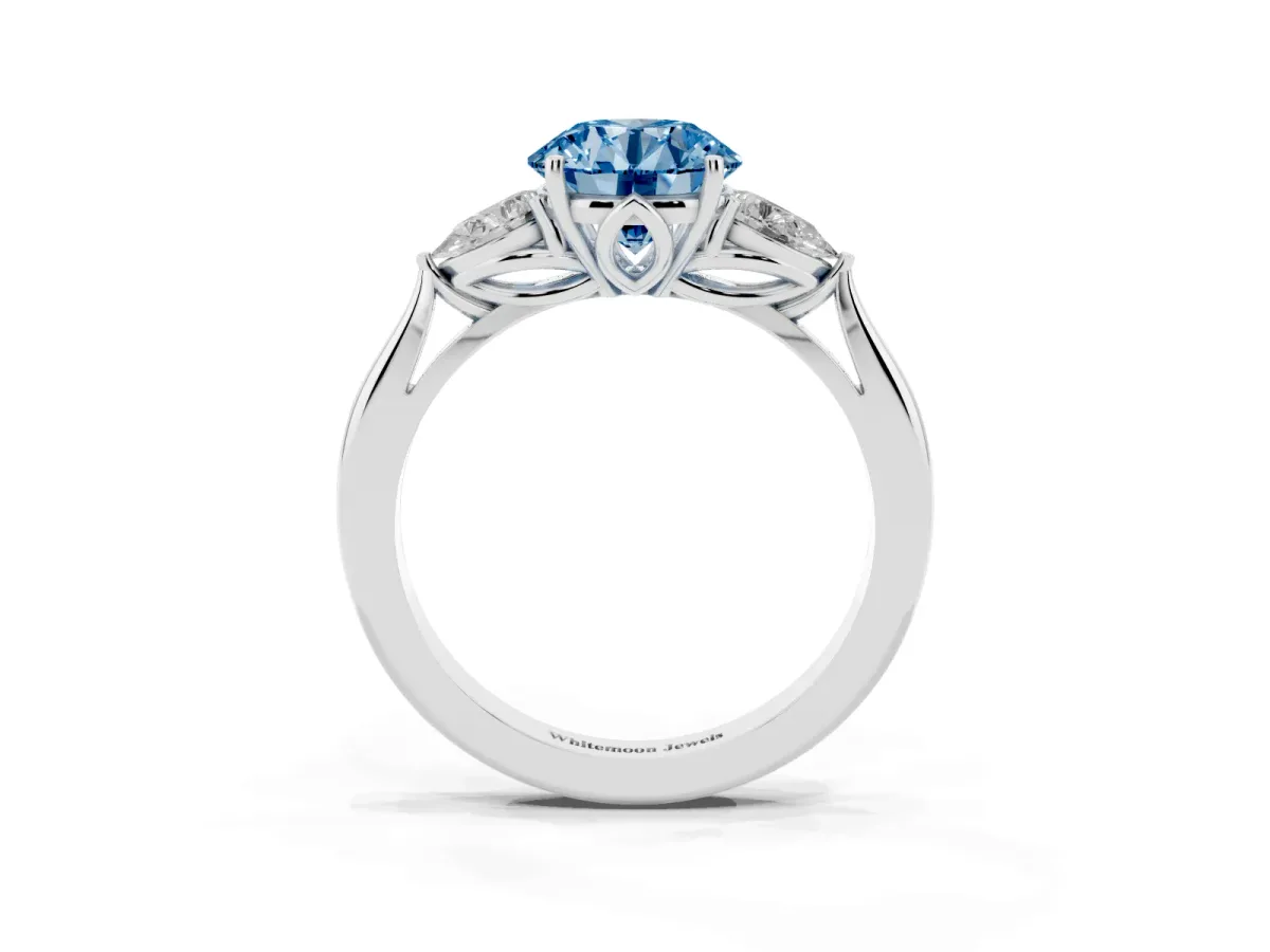 Fancy Blue Round Cut Diamond Three-Stone Ring with Pear Side Stones and Prong Setting Platinum