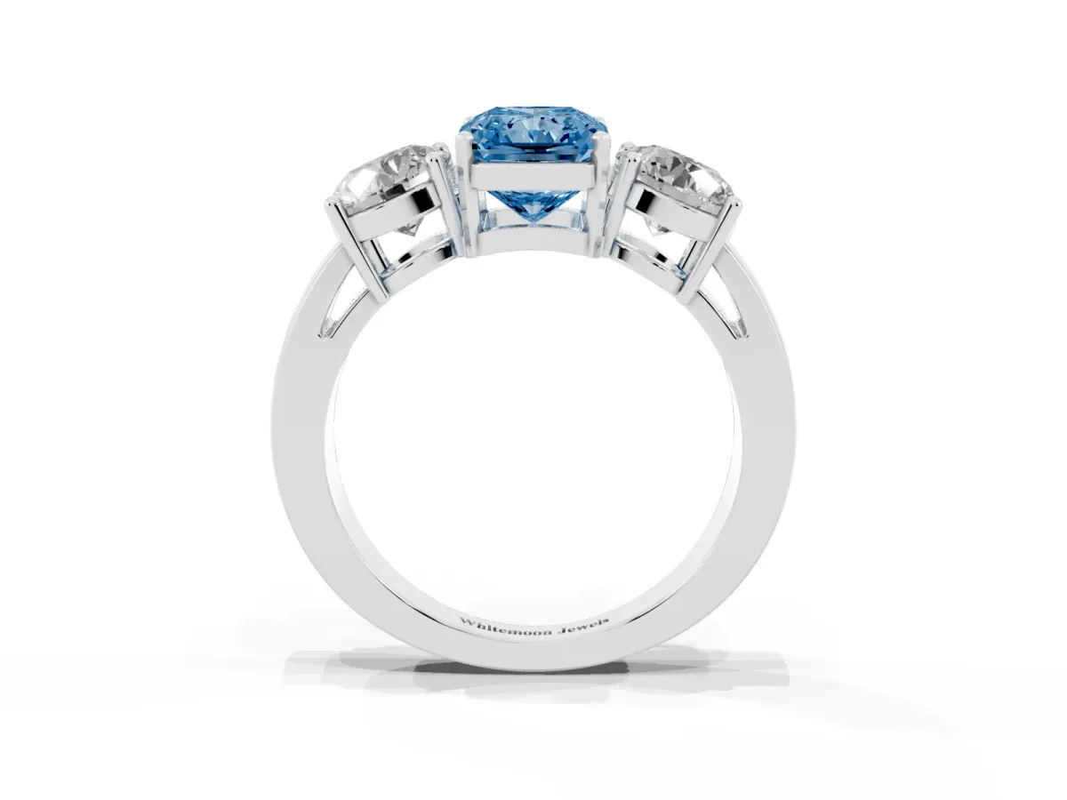 Fancy Blue Three-Stone Radiant Cut Diamond Ring with Round Side Stones, Classic Band, and Four-Prong Setting Platinum