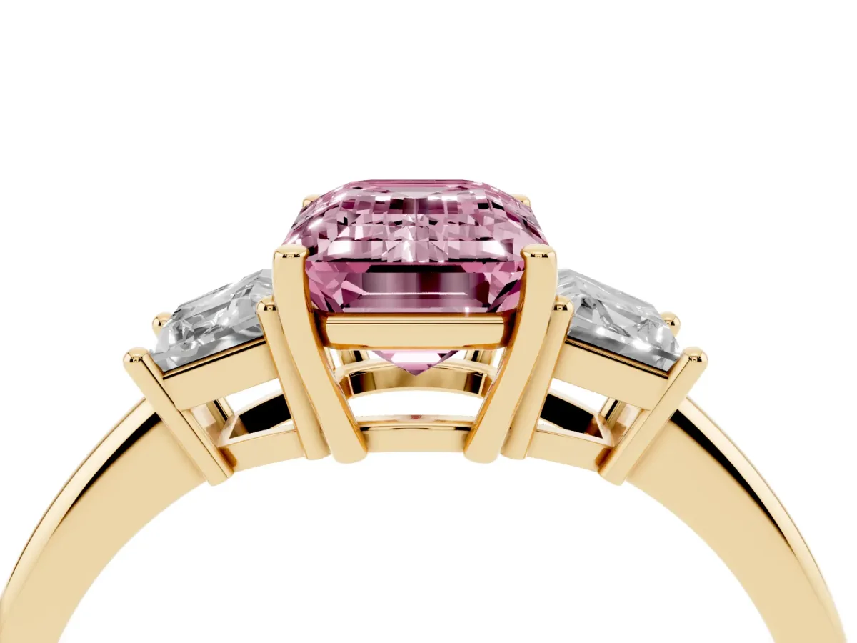 Fancy Pink Emerald Cut Diamond Three-Stone Ring with Trapezoid Side Stones and Prong Setting Yellow gold