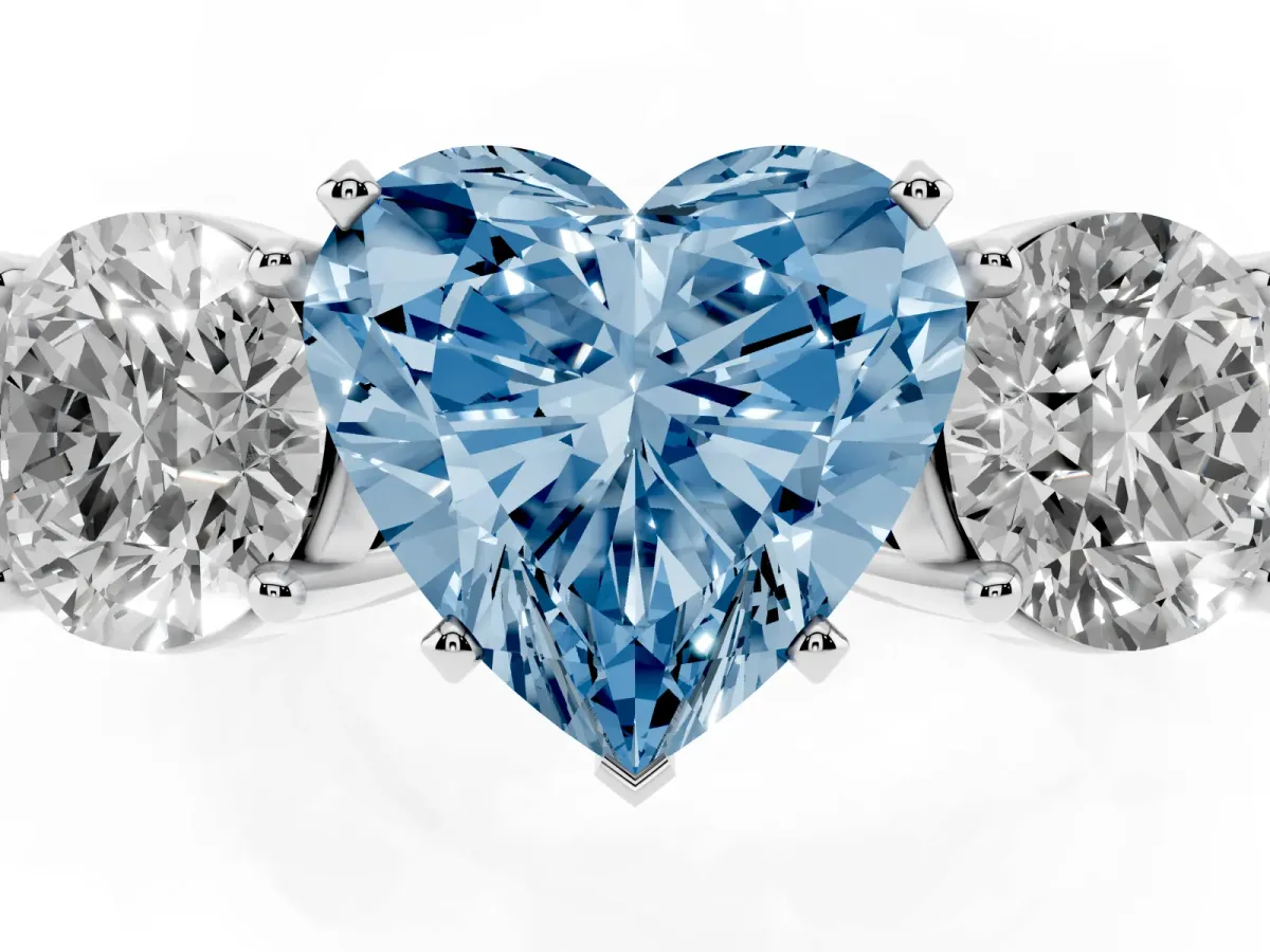 Fancy Blue Three-Stone Heart Cut Diamond Ring with Round Side Stones, Classic Band, and Four-Prong Setting Platinum