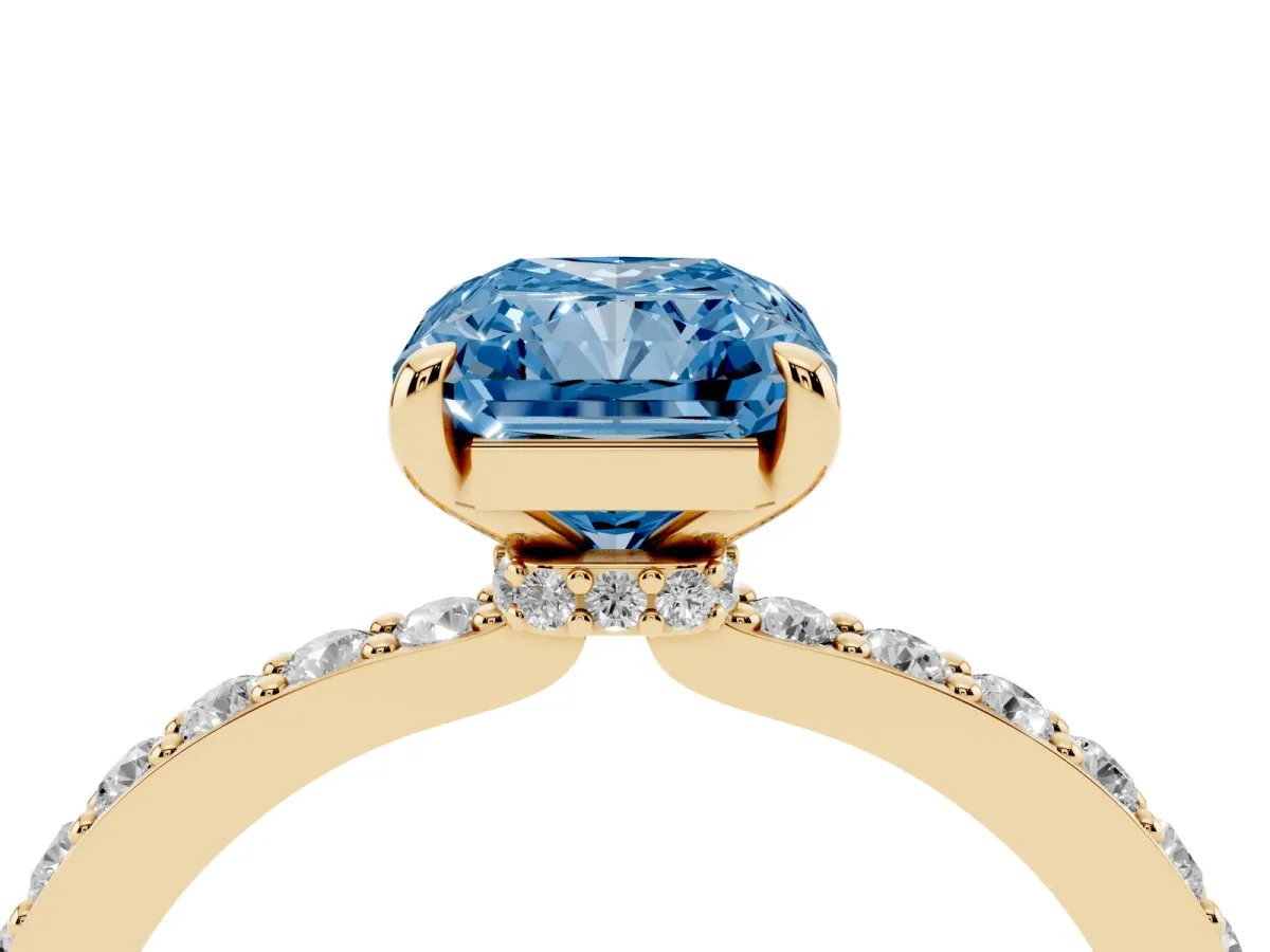 Fancy Blue Radiant Cut Diamond Pavé Engagement Ring with Round Accents and Prong Setting Yellow gold