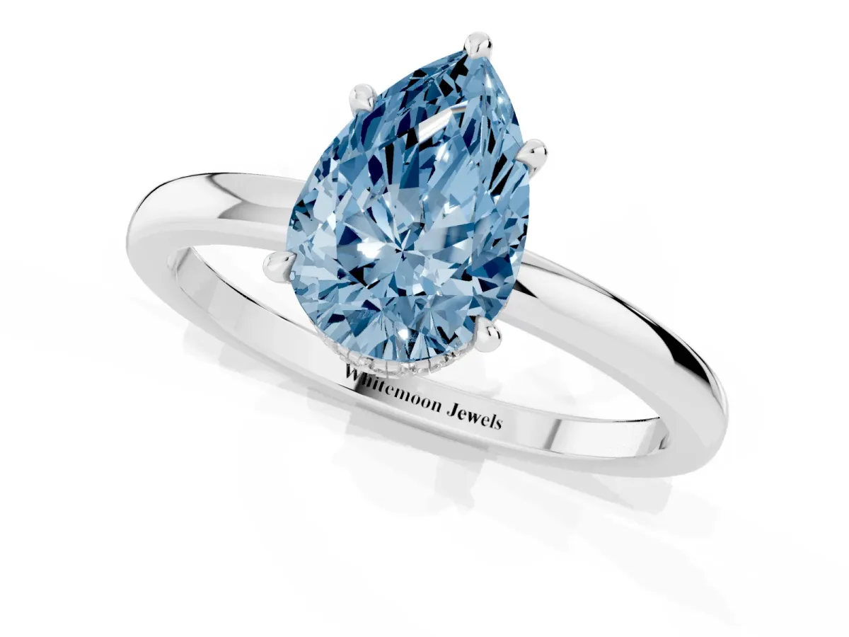 Fancy Blue Pear Cut Solitaire Engagement Ring with Cathedral Band and Four-Prong Setting White gold