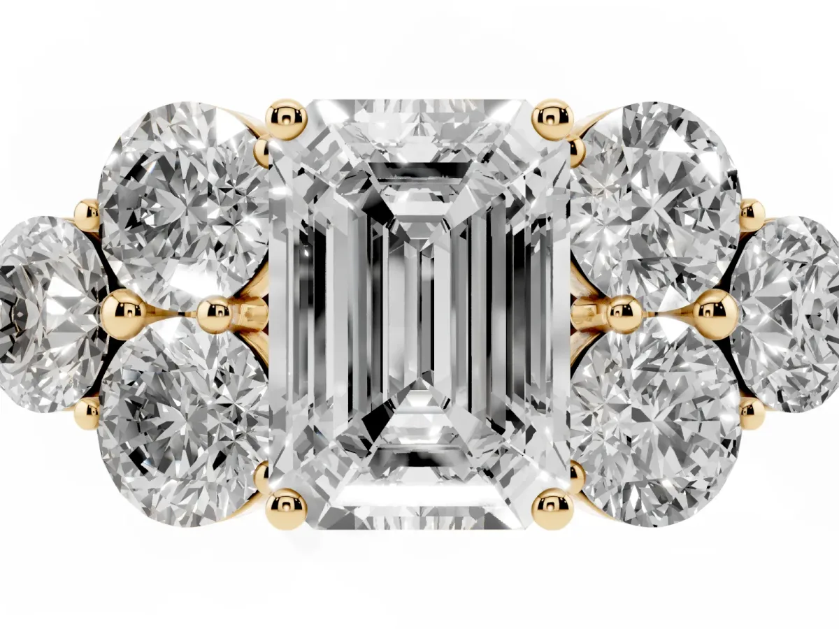 Emerald Cut Cut Diamond Cluster Ring with Round Accent Stones and Prong Setting on a Classic Band Yellow gold