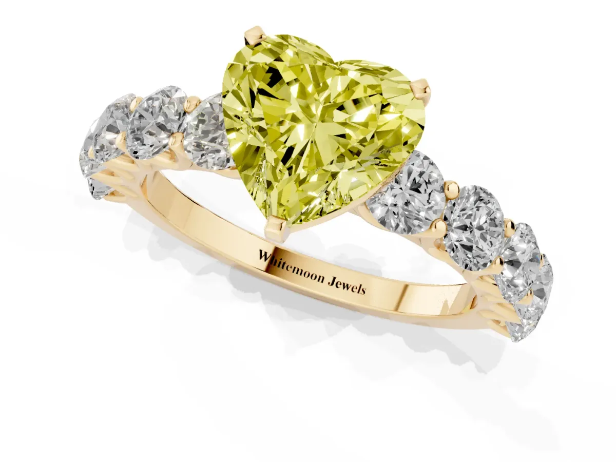 Fancy Yellow Heart Cut Diamond Prong Setting with Side Stones on a Pave Band Yellow gold
