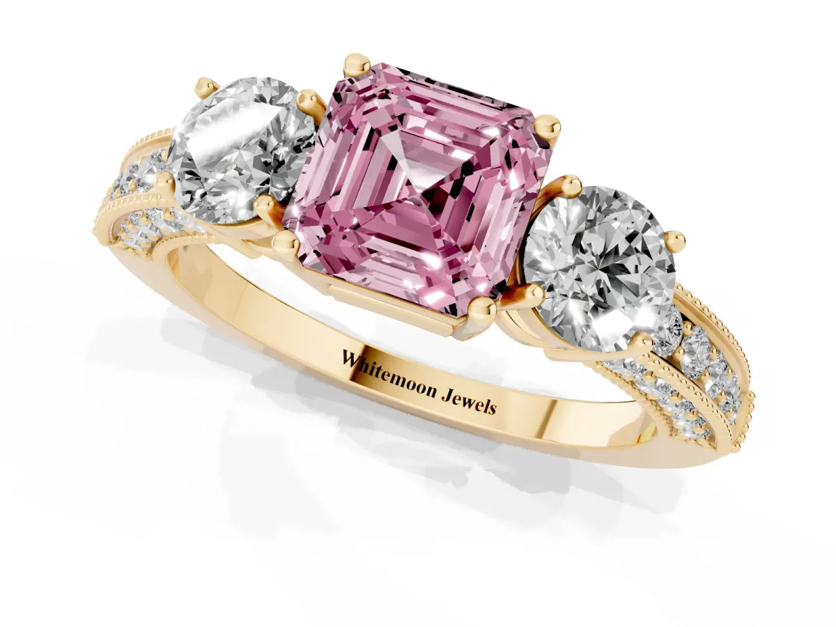 Fancy Pink Asscher Cut Three-Stone Diamond Ring with Pavé Band and Four-Prong Setting Yellow gold