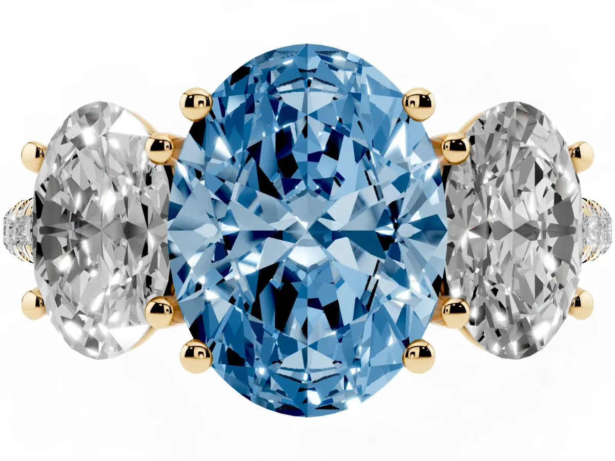 Fancy Blue Three-Stone Oval Cut Diamond Ring with Round Pavé Band and Prong Setting Yellow gold