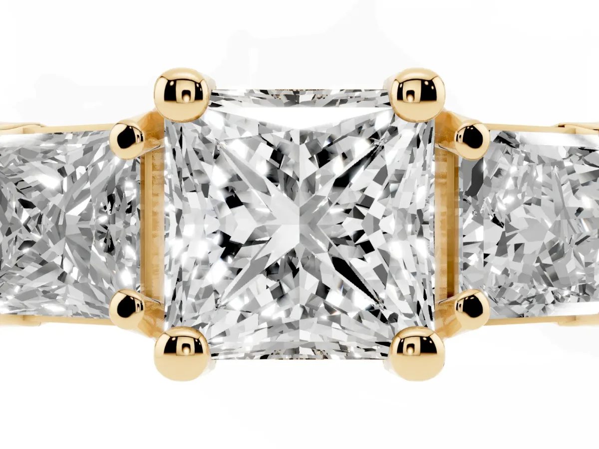Princess Cut Diamond Three-Stone Ring with Channel Set Band and Four-Prong Setting Yellow gold