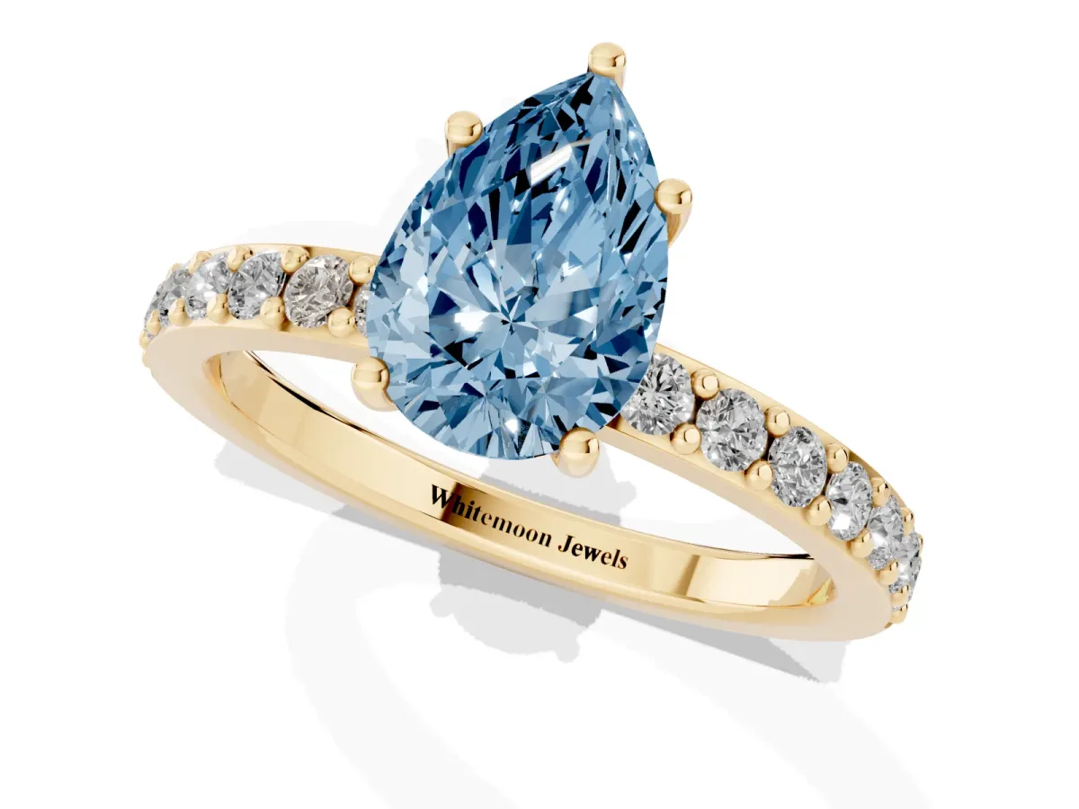 Fancy Blue Pear Cut Cut Diamond Solitaire with Pave Band and Four-Prong Setting Yellow gold