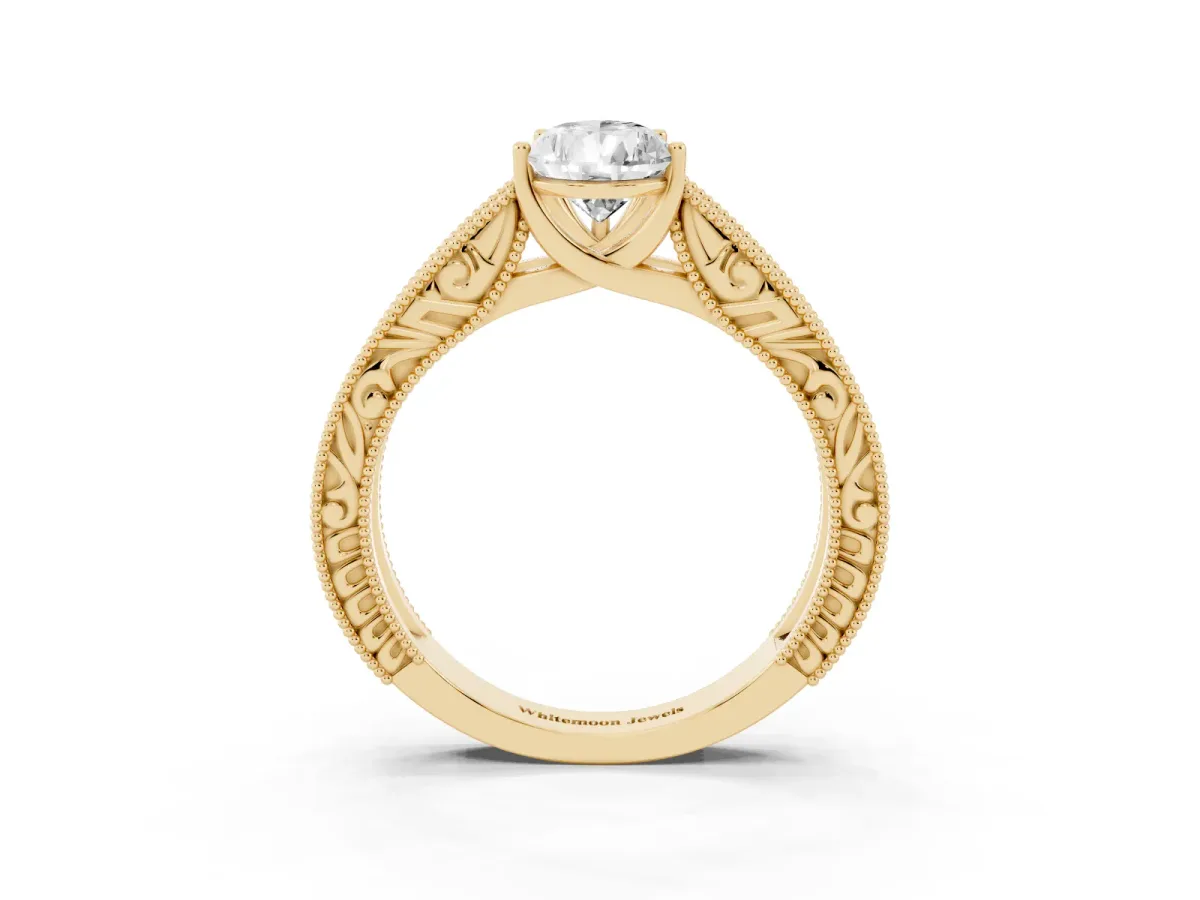 Pear Cut Diamond Solitaire Ring with Engraved Band and Four-Prong Setting Yellow gold