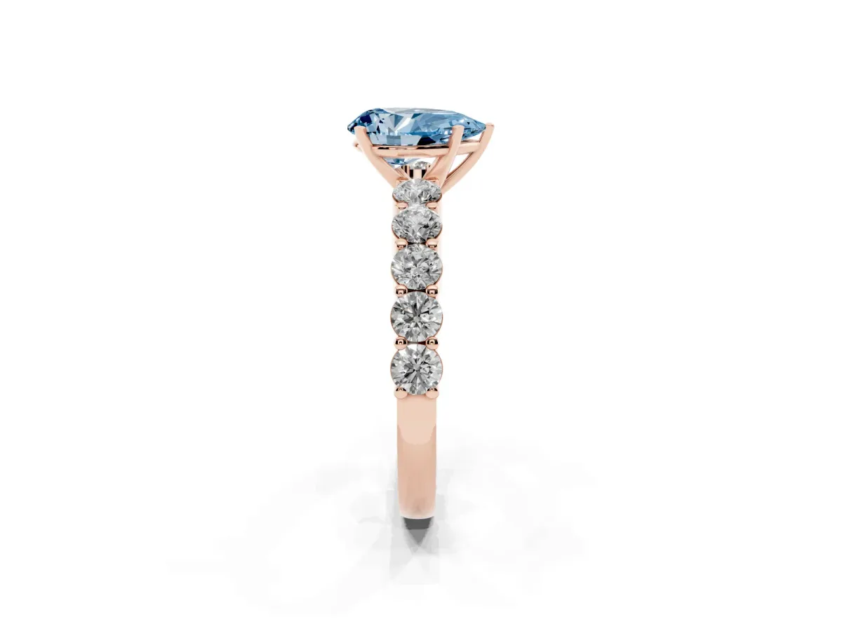 Fancy Blue Pear Cut Diamond Solitaire Ring with Shared Prong Round Side Stones Rose gold