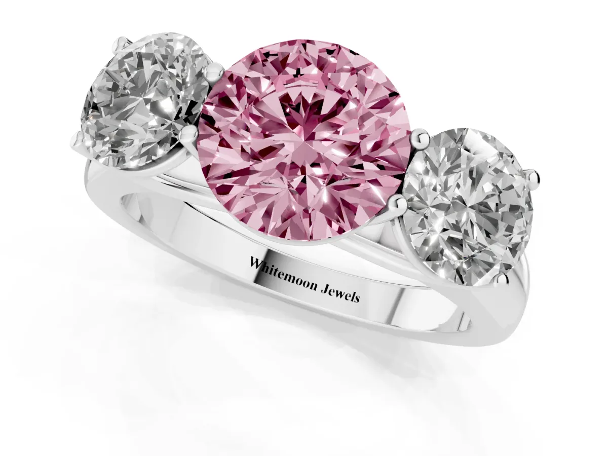 Fancy Pink Round Cut Three-Stone Diamond Ring with Prong Setting on a Classic Band Platinum