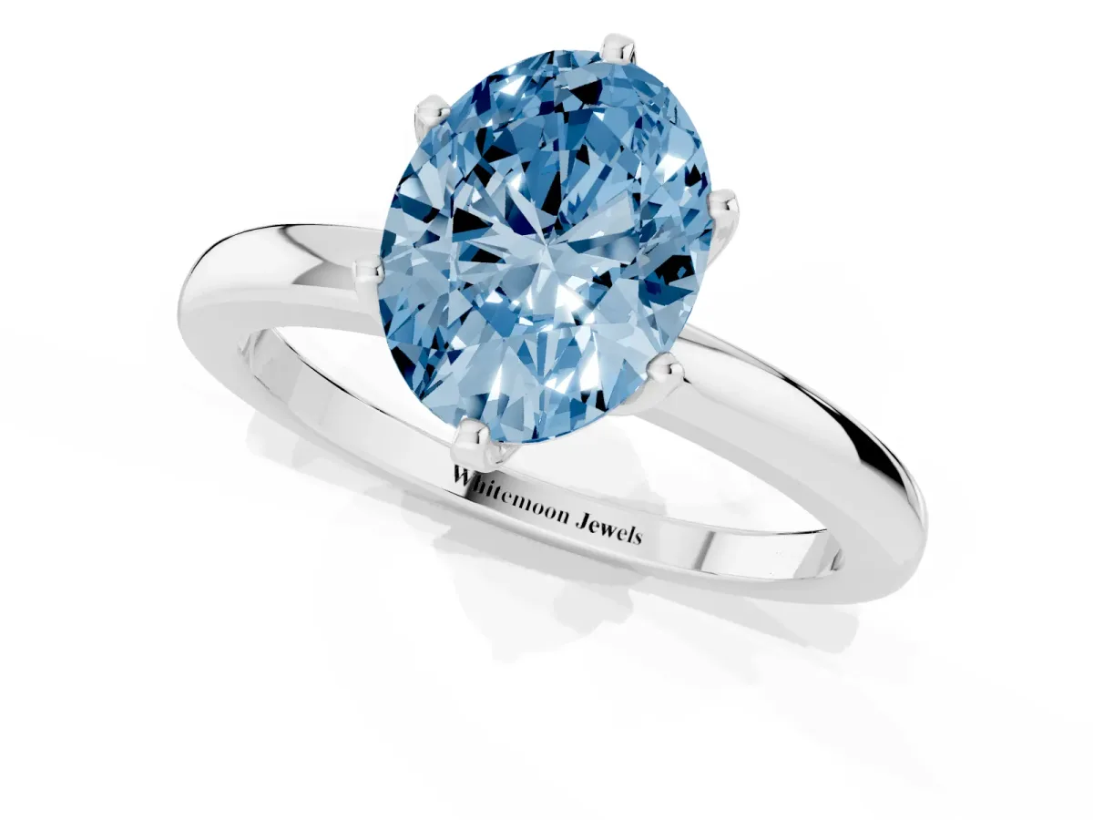Fancy Blue Oval Cut Solitaire Diamond Ring with Six-Prong Setting on a Classic Band Silver