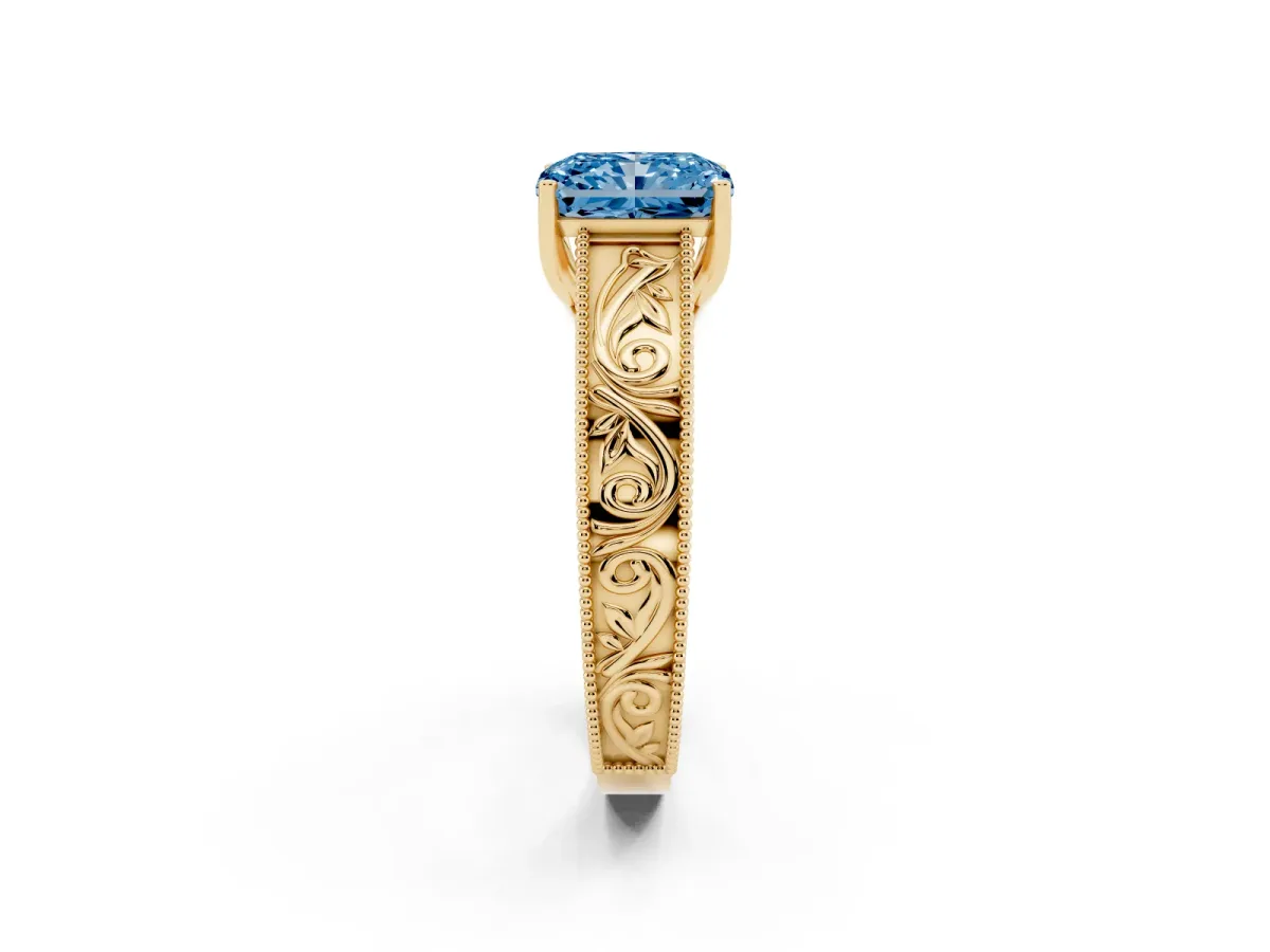 Fancy Blue Radiant Cut Diamond Solitaire Ring with Engraved Band and Four-Prong Setting Yellow gold
