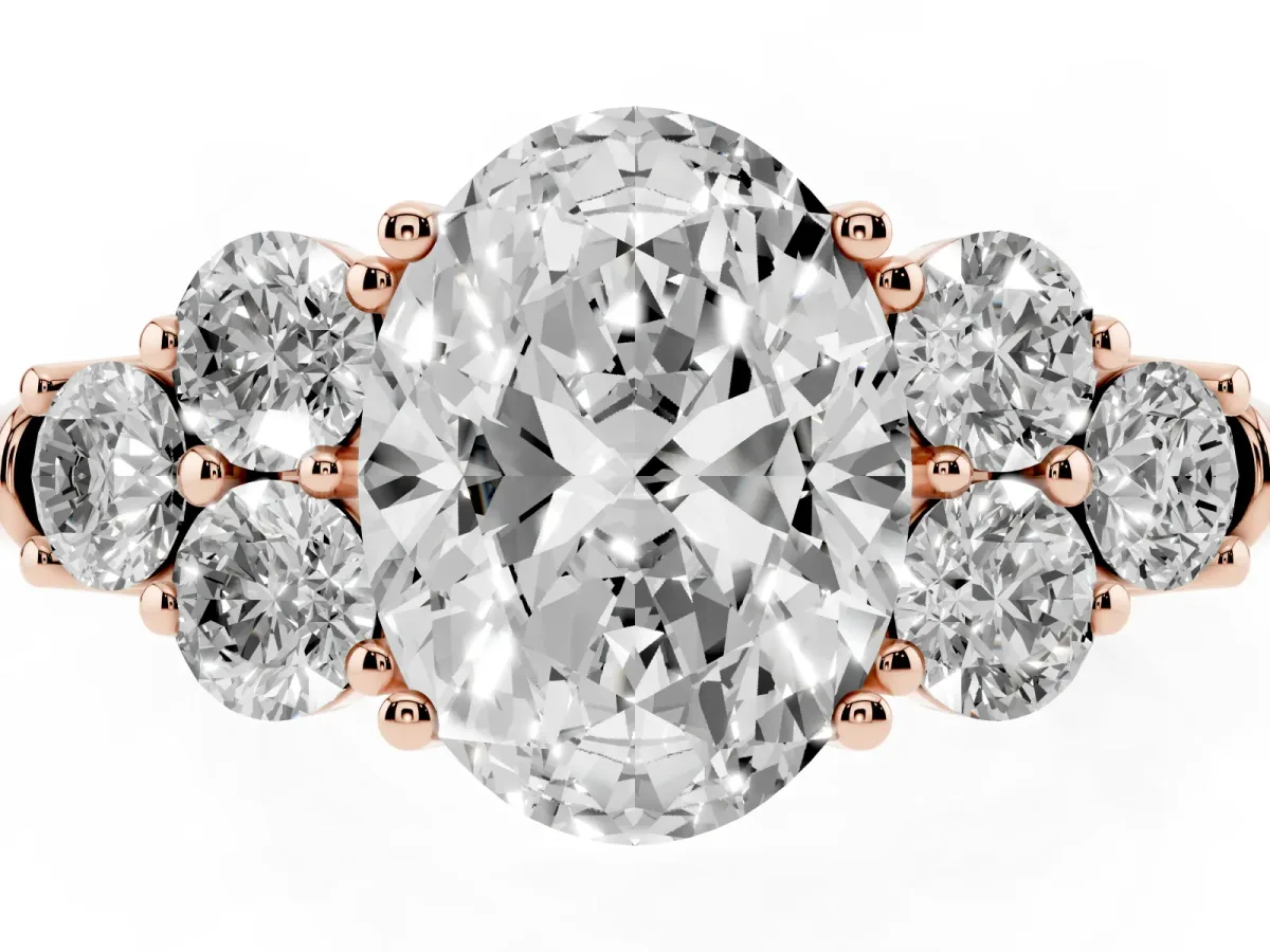 Oval Cut Cut Diamond Cluster Ring with Round Accent Stones and Prong Setting on a Classic Band Rose gold
