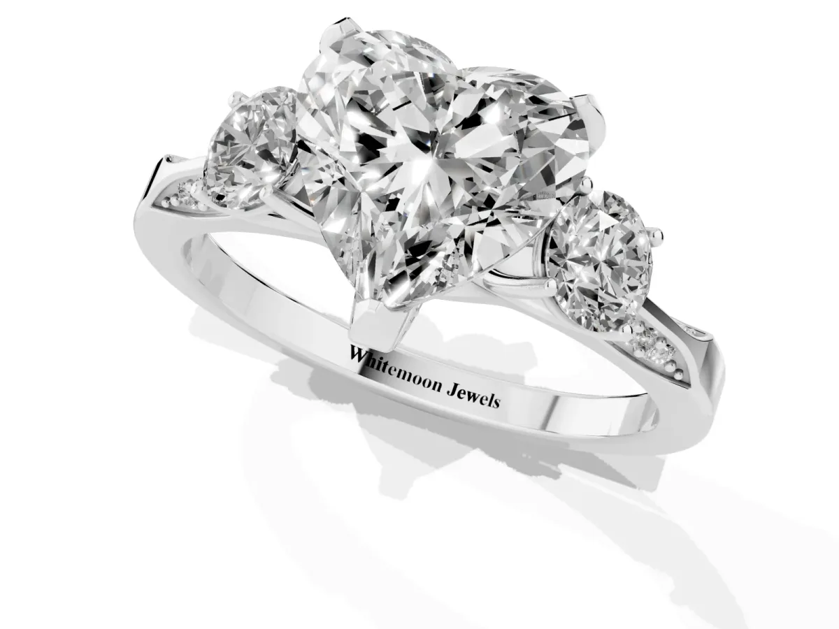 Heart Cut Brilliant Three-Stone Diamond Ring with Pavé Band and Four-Prong Setting Platinum