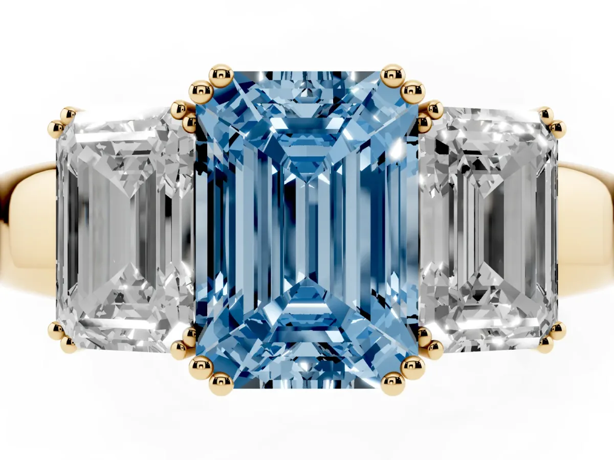 Fancy Blue Three-Stone Emerald Cut Cut Diamond Ring with Channel Set Band and Four-Prong Setting Yellow gold