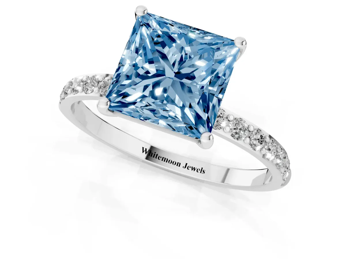 Fancy Blue Princess Cut Diamond Solitaire Ring with Round Pavé Shoulders and Prong Setting Silver