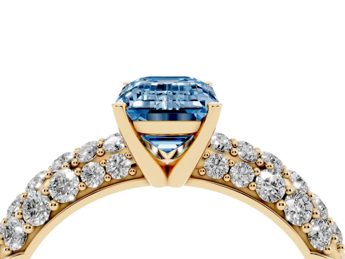Fancy Blue Emerald Cut Diamond Pavé Band Solitaire Ring with Four-Prong Setting Yellow gold
