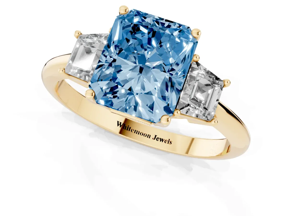 Fancy Blue Radiant Cut Diamond Three-Stone Ring with Trapezoid Side Stones and Prong Setting Yellow gold