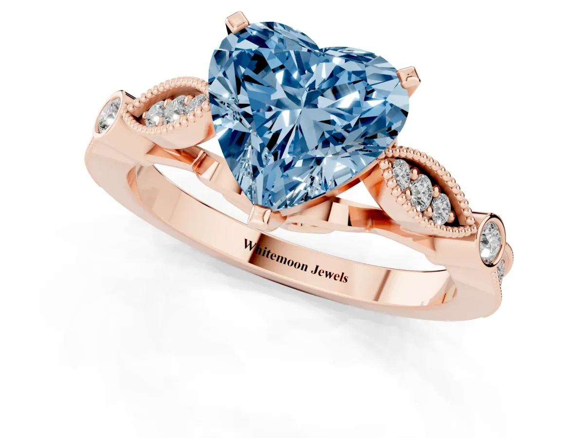 Fancy Blue Heart Cut Cut Diamond with Milgrain Marquise and Bezel Accents on a Solitaire Band with Prong Setting Rose gold