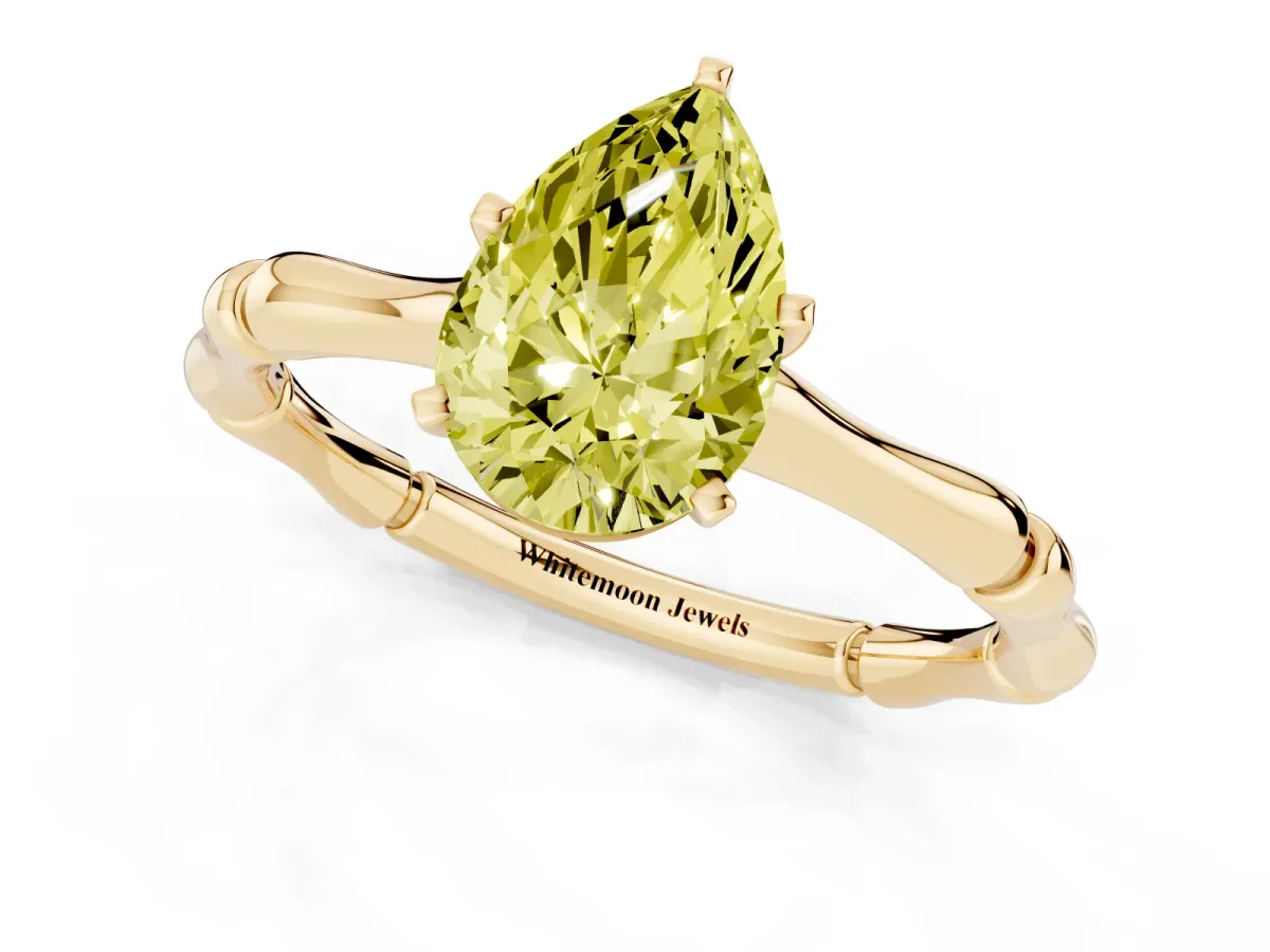 Fancy Yellow Pear Cut Solitaire Diamond Ring with Bamboo Band and Four-Prong Setting Yellow gold