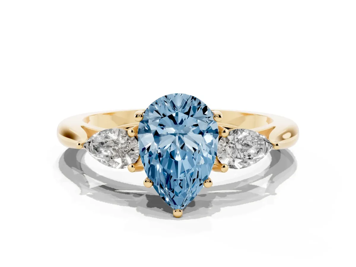 Fancy Blue Three-Stone Pear Cut Brilliant Diamond Solitaire Ring with Tapered Band and Four-Prong Setting Yellow gold