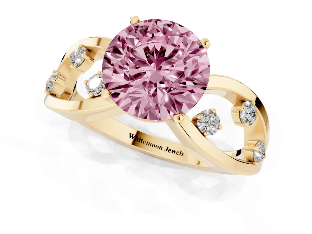Fancy Pink Round Cut Cut Solitaire Diamond with Side Stones on Criss-Cross Band and Four-Prong Setting Yellow gold