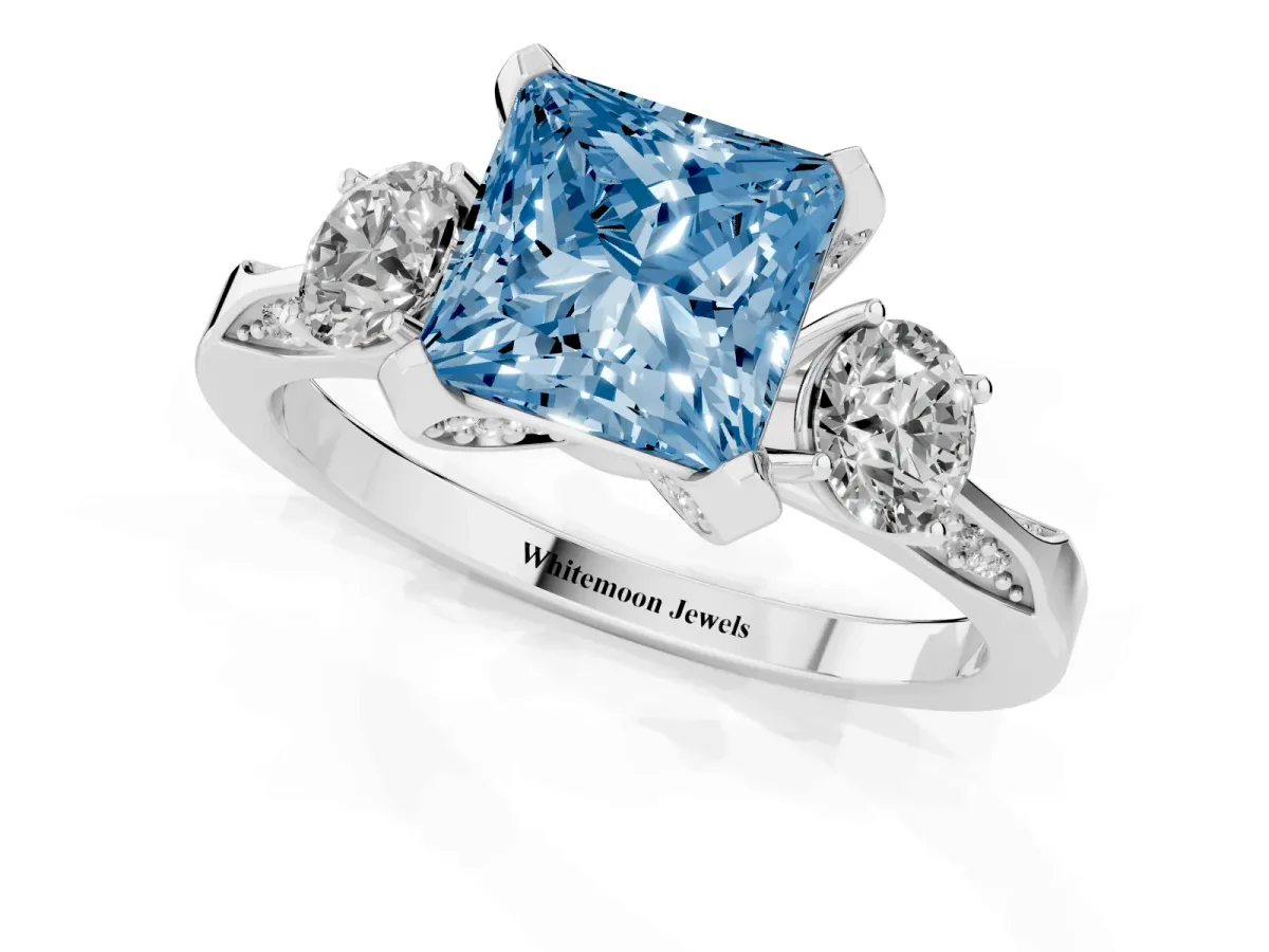 Fancy Blue Princess Cut Brilliant Three-Stone Diamond Ring with Pavé Band and Four-Prong Setting Silver