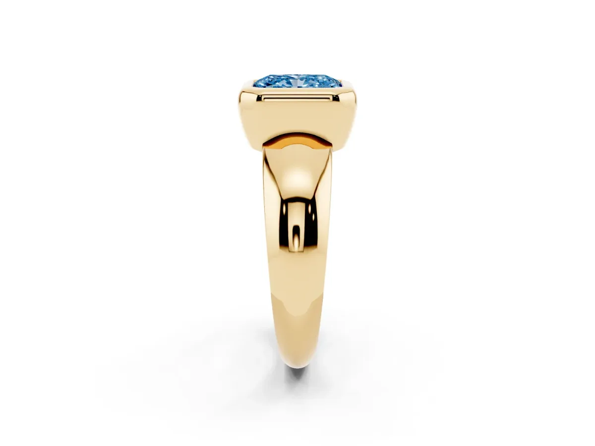 Fancy Blue Bezel Set Radiant Cut Solitaire Ring with Wide Band Yellow gold