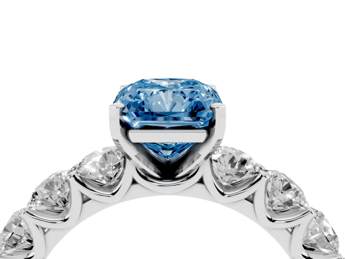 Fancy Blue Radiant Cut Diamond Prong Setting with Side Stones on a Pave Band Platinum