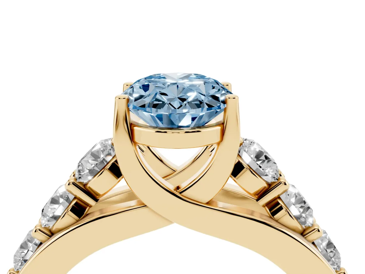 Fancy Blue Oval Cut Diamond Engagement Ring with Pavé Band and Four-Prong Setting Yellow gold