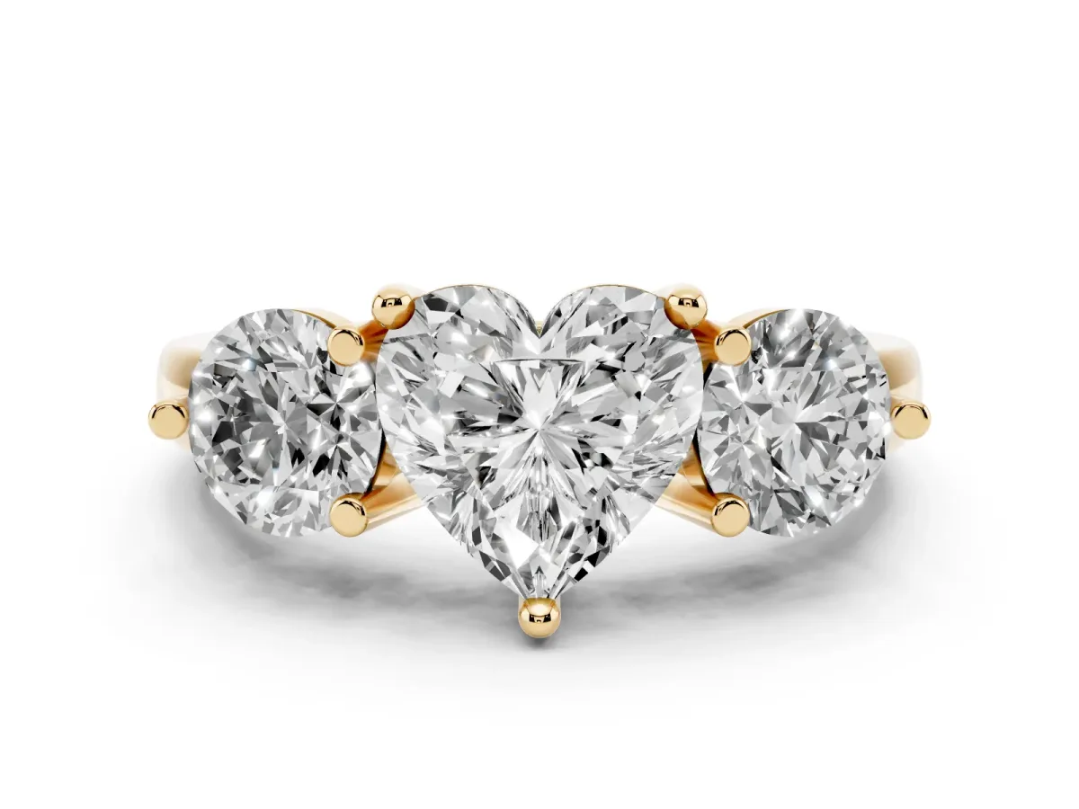 Three-Stone Heart Cut Brilliant Cut Solitaire Ring with Prong Setting on a Classic Band Yellow gold