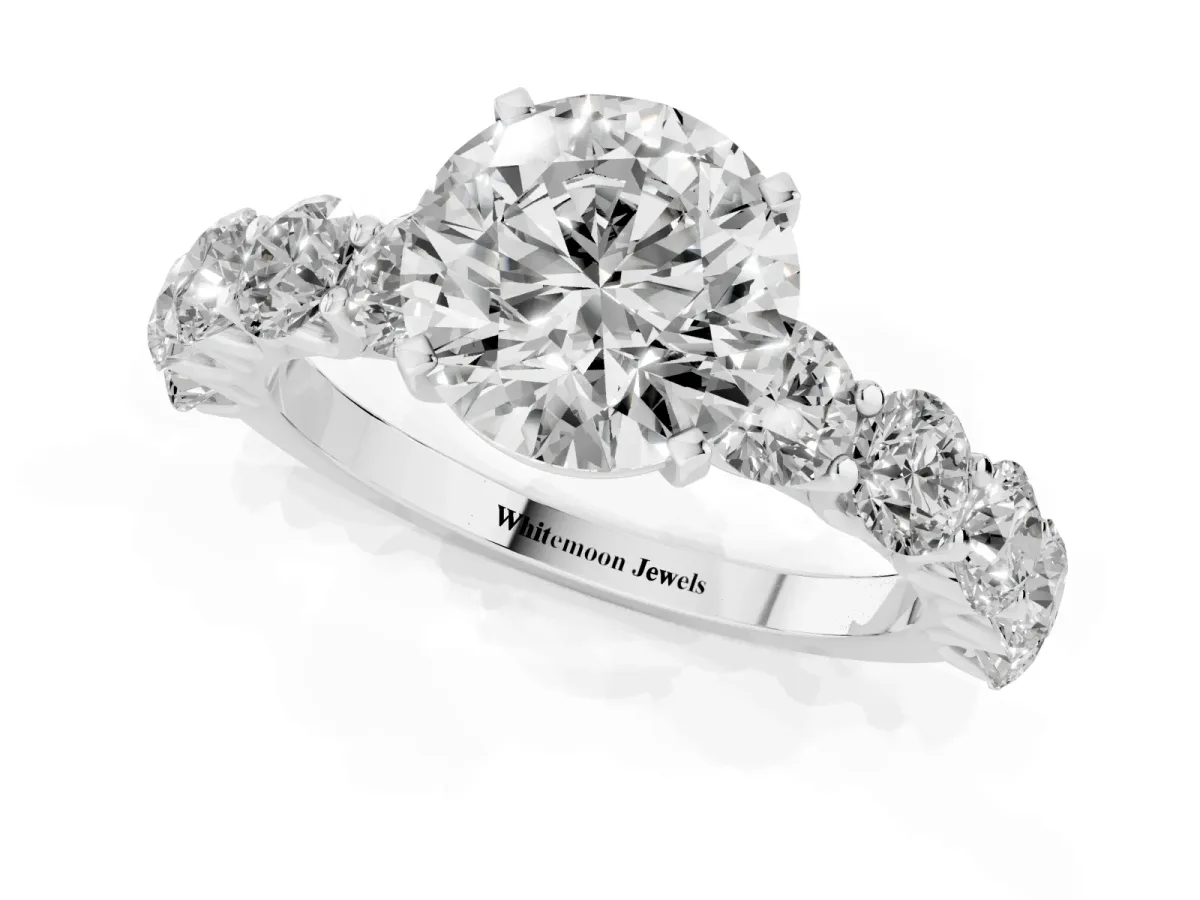 Round Cut Diamond Prong Setting with Side Stones on a Pave Band Silver
